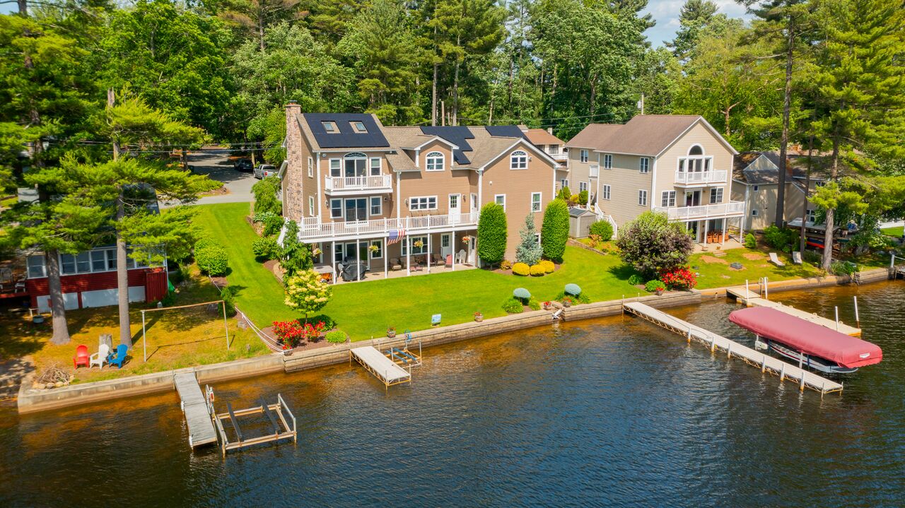 Aerial view of a New England home with an all-black Rooftop Power solar installation